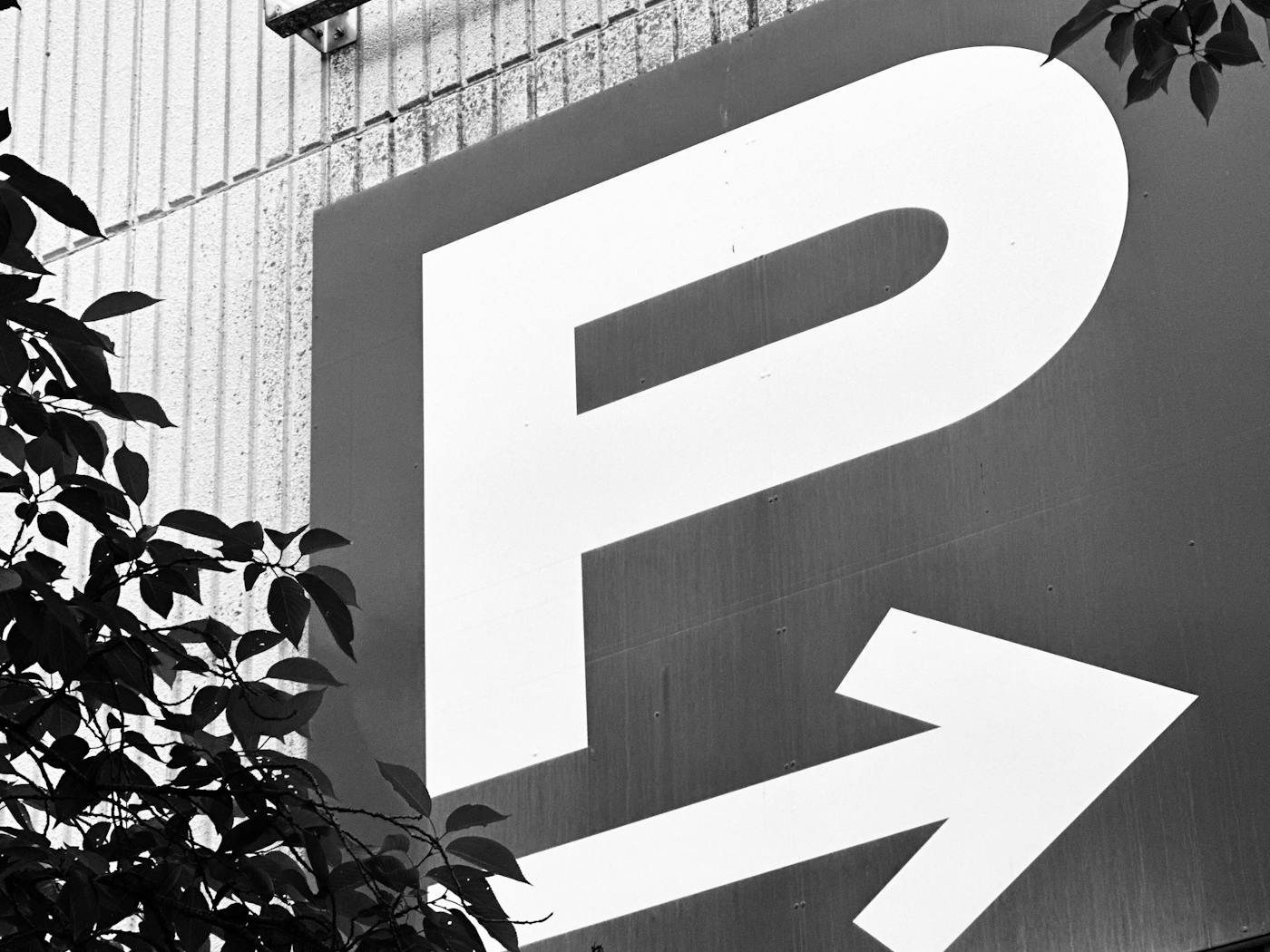 Parking sign with a P and a directional arrow